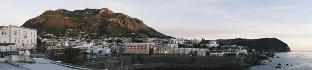 Panorama of Forio and Monte Epomeo in pink evening light.
