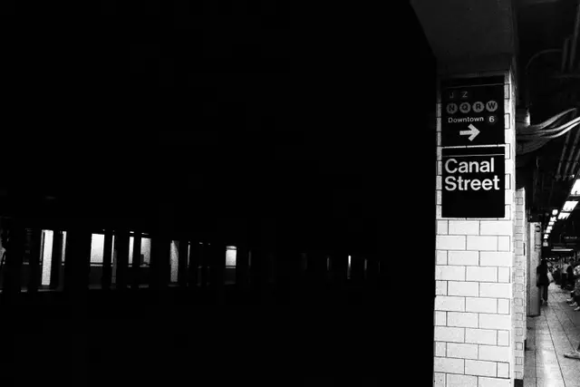 Black and white: a dark subway platform, a tiled column signed Canal Street.